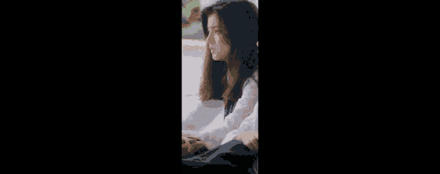a group of people are sitting in front of a window . one of the people is wearing a watch .