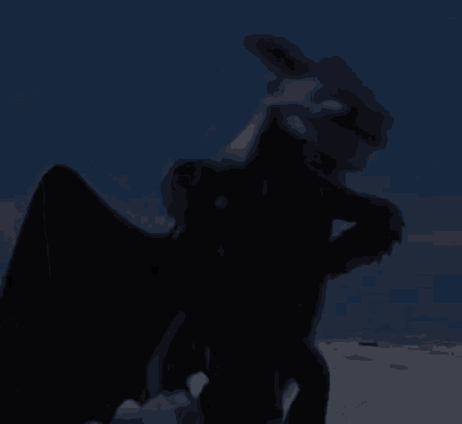 a toothless from how to train your dragon is standing in the dark .