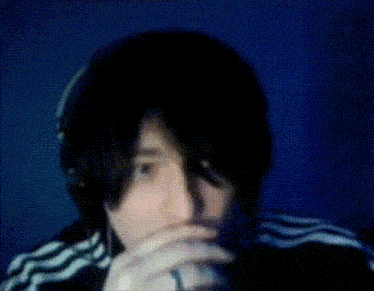 a blurry picture of a person covering their face