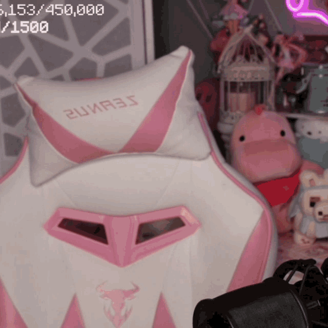 a pink and white gaming chair with a pillow that says 2uir35