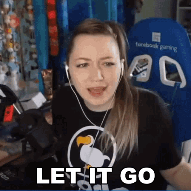 a woman wearing headphones and a black shirt that says let it go
