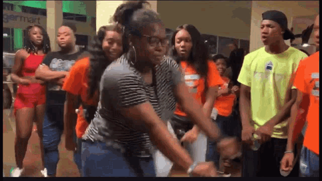 a group of young people are dancing in front of a sign that says ' germart '