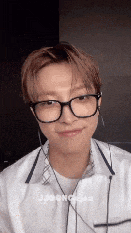 a close up of a person wearing glasses and earphones