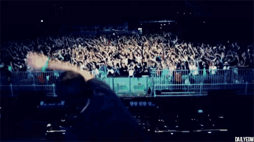 a dj is playing music in front of a crowd with the words dailyedm below him