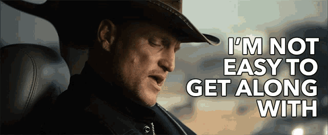 a man in a cowboy hat is sitting in a car and says i 'm not easy to get along with