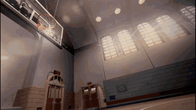 a basketball hoop in a gym with a sign on the wall that says exit