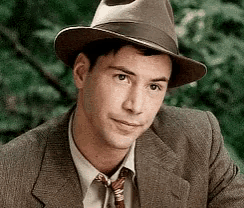 a man wearing a suit and tie is wearing a hat