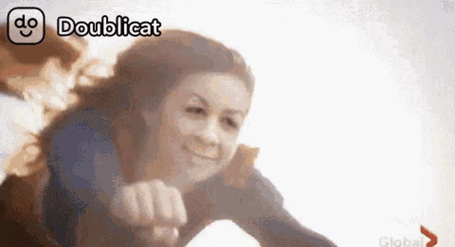 a woman in a superhero costume is flying through the air with the words doublecat above her