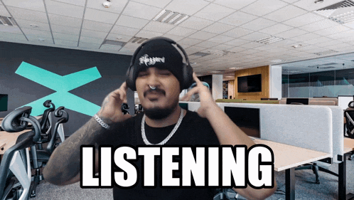a man wearing headphones has the word listening written on his face