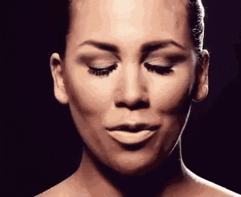 a close up of a woman 's face with closed eyes