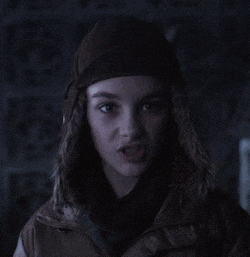 a woman wearing a furry hat and a brown jacket
