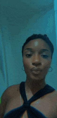 a woman in a black top is taking a selfie