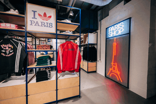 a store with a sign that says i love paris and a neon sign that says paris shop