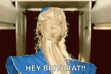 a woman with blonde hair is wearing a blue uniform and says hey britbrat .