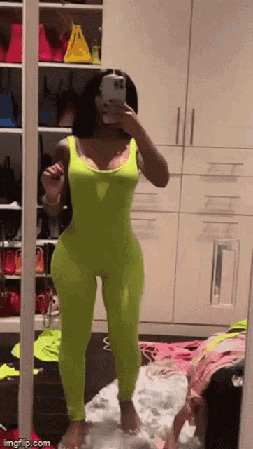 a woman is taking a picture of herself in a mirror