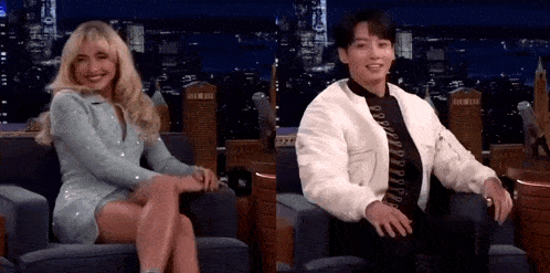 a man and a woman are sitting next to each other in a chair .
