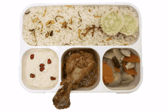 a tray of food with rice chicken vegetables and pomegranate seeds