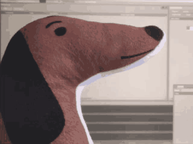 a stuffed dachshund with a long neck and black ears
