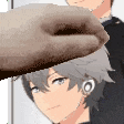 a close up of a person 's hand reaching out towards a person 's face .