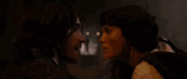 a man and a woman are looking into each others eyes