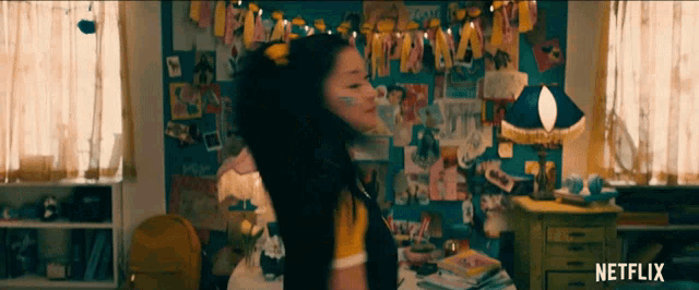 a girl in a room with a netflix logo on the bottom right