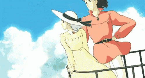 a man in a red shirt and a woman in a yellow dress are standing on a balcony