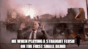 a man in a suit and tie is standing in front of a building that is on fire .