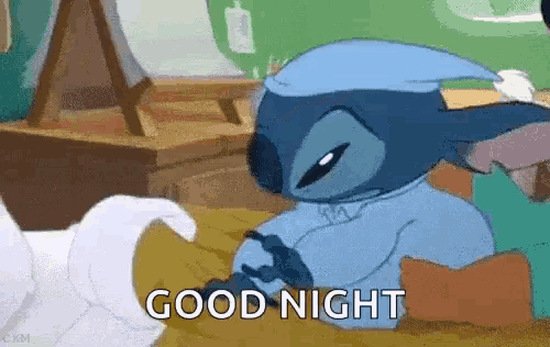 a cartoon character is laying on a bed with the words `` good night '' written next to him .