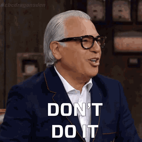 a man wearing glasses and a suit says " don 't do it "