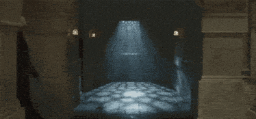 a dark hallway with a few lights on the wall