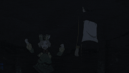 a man and a woman are standing in the dark and the woman is wearing a bunny hat