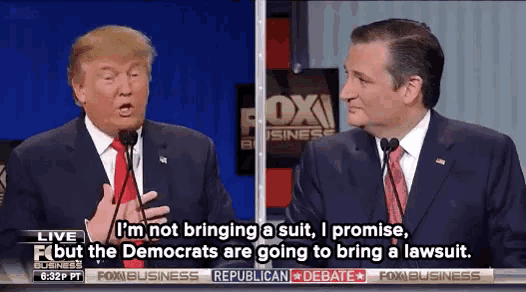 two men in suits and ties are talking in front of microphones in front of a fox business sign