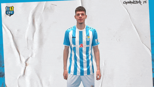 a man in a blue and white striped shirt holds a soccer ball in his hand