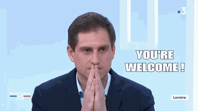 a man in a suit says " you 're welcome " on a blue background