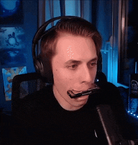 a man wearing headphones and playing a harmonica