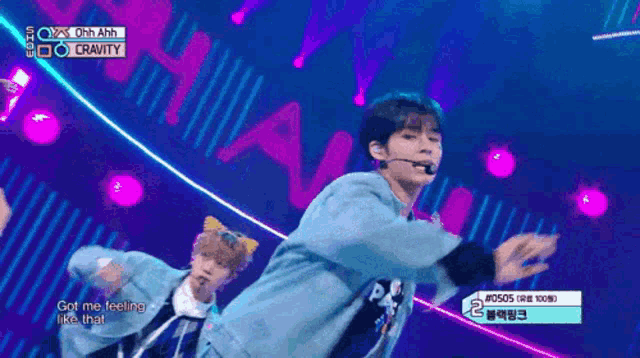 two boys are performing on a stage and one of them is wearing a cat ear headband
