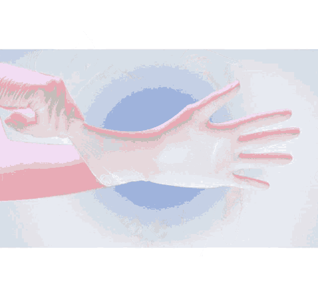 a person wearing a pink and white glove on their arm