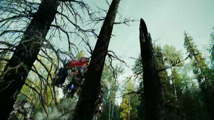 a helicopter is flying through a forest with trees in the foreground