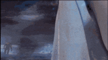 a blurred image of a person standing in front of a wall
