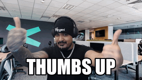 a man giving a thumbs up with the words thumbs up behind him