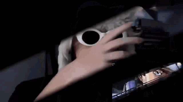 a man wearing sunglasses and a hat is looking at a picture of a man in a hat .