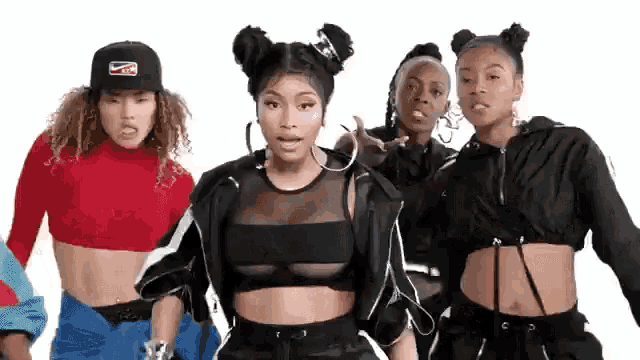 a group of women are standing next to each other on a white background . one of the women is wearing a crop top .