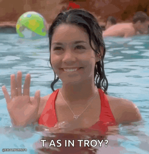 a woman in a red bikini is swimming in a pool and waving at someone .