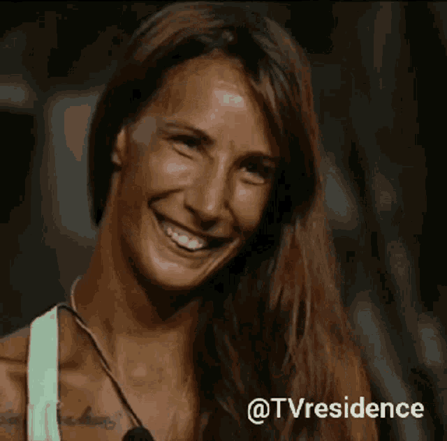 a woman is smiling and holding her hand to her forehead with the words @tvresidence below her