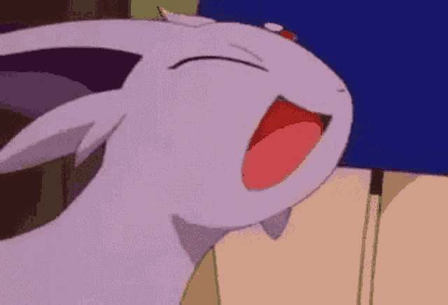 a close up of a cartoon character with its mouth open and its tongue out .