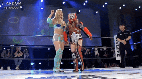 two female wrestlers are in a ring with a sign that says stardom