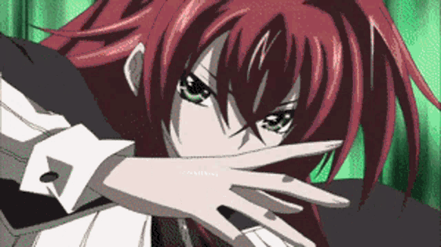 a girl with red hair and green eyes is making a stop sign