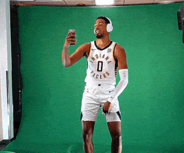 a man wearing headphones and a jersey that says indiana racers