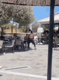 a group of people are sitting at tables in a restaurant .