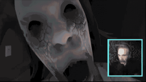 a man is playing a video game with a ghost face in the background